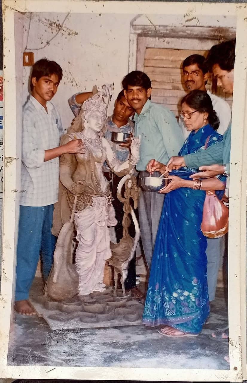 Basanta Kumari Samanta with a group of young sculptors finishing a clay idol of a goddess